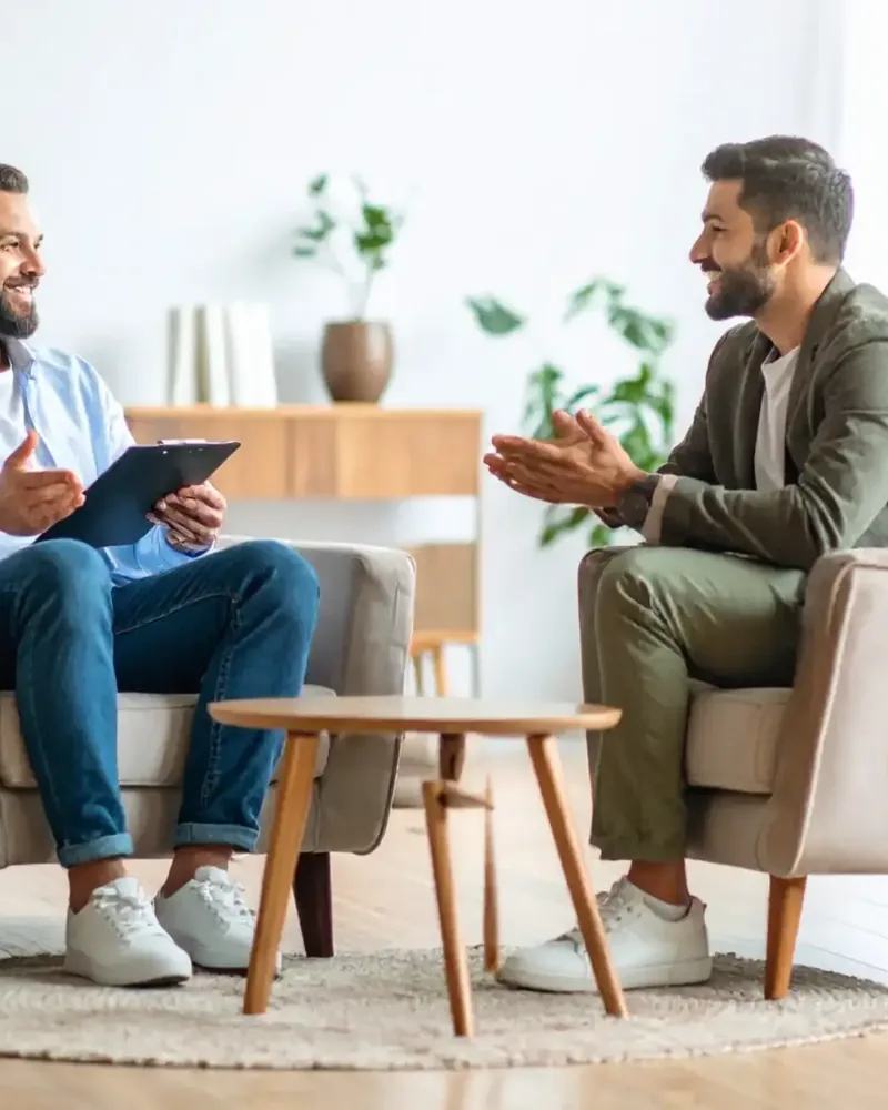 Two people talking through a care plan in a bright consultation room