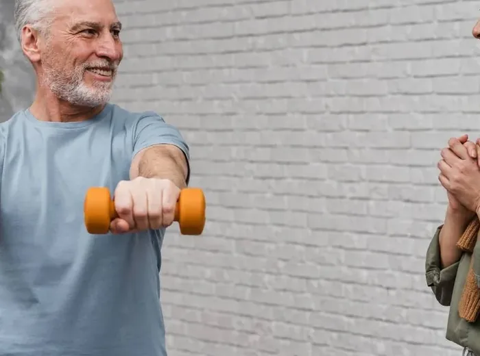 Older adult doing supervised strength work with resistance equipment